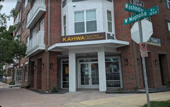 Exterior of a Kahwa Coffee cafe on a corner brick building