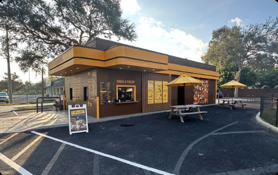 Freestanding Kahwa Coffee cafe with a drive-thru lane