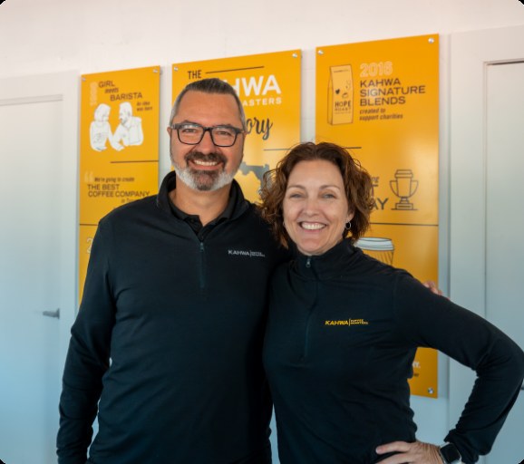Raphael and Sarah Perrier standing together inside a Kahwa Coffee cafe