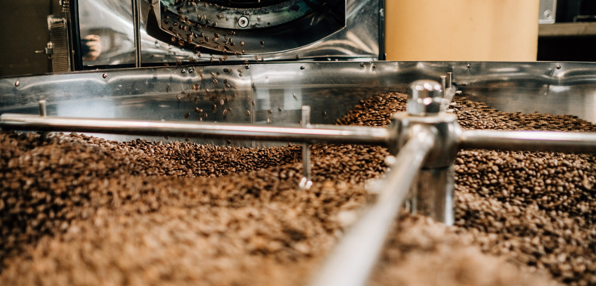 Coffee beans tumbling in a stainless steel roaster drum at Kahwa Coffee
