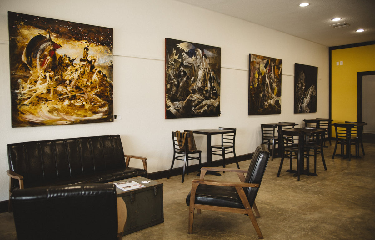 Local artists' paintings on the wall of the Kahwa Largo cafe