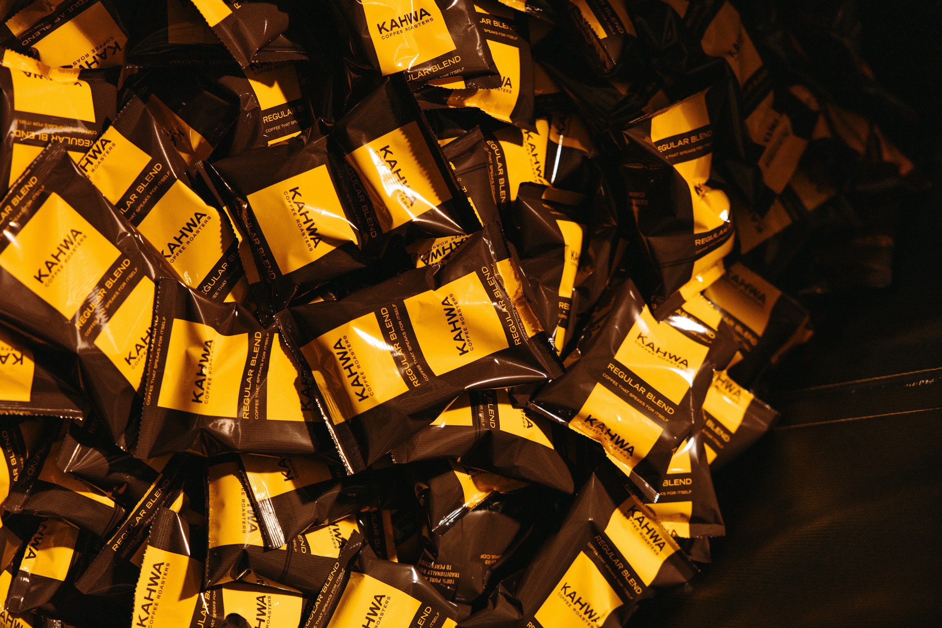 A pile of Kahwa Regular Blend single-serve coffee packets